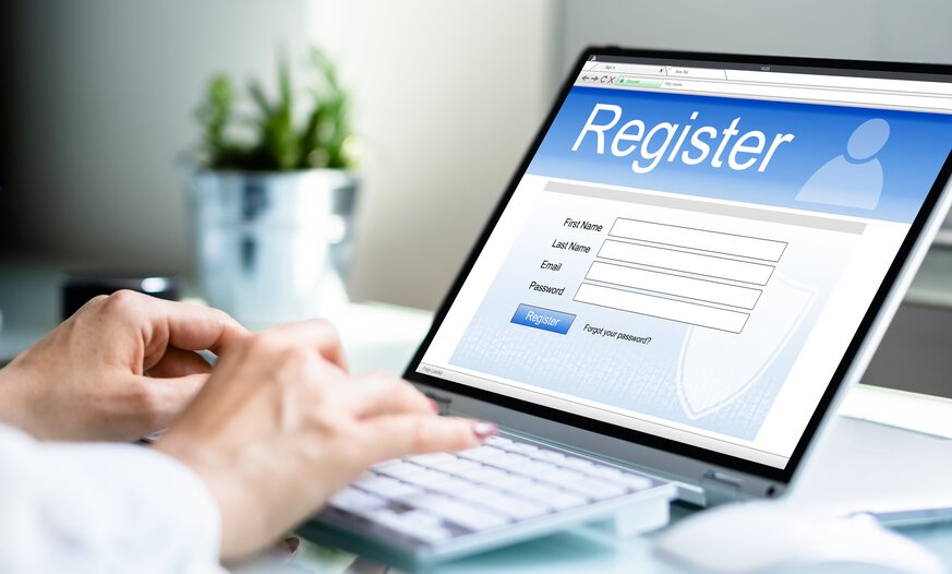 Hände tippen Daten in Register am Laptop