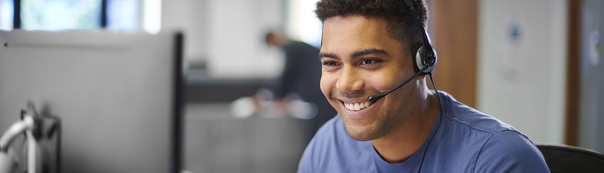 Junger Mann mit Headset Junger Mann mit Headset in Büro